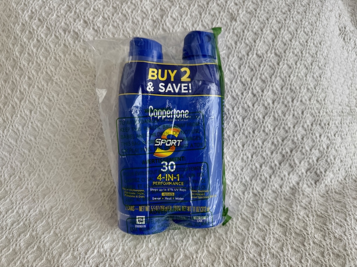 Image of a pack of two Coppertone Sport Sunscreen Spray bottles, each with SPF 30 protection. The bottles are blue with yellow and white text, prominently displaying the Coppertone logo and 'Sport' branding. The label highlights features like water resistance for up to 80 minutes and broad-spectrum UVA/UVB protection. The spray nozzle is designed for easy application, ideal for active outdoor activities. The two bottles are shown side by side against a plain background, with product details clearly visible.